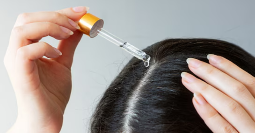 Applying aloe vera and castor oil mixture to scalp for hair growth