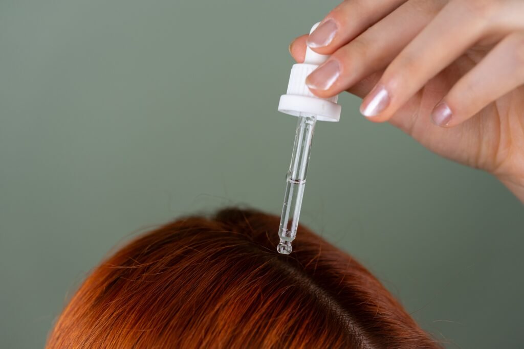 Woman applying hair oil with scalp massage